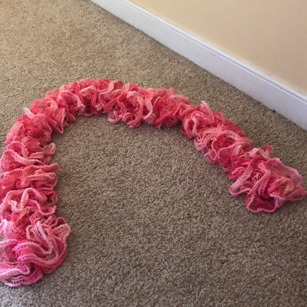 Handmade pink crocheted scarf.